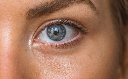 Close-up of a person's eye with the text "Your Ultimate Guide to Revitalizing Dry Winter Skin" overlaying the image, offering a glimpse into the comprehensive skincare blog. The image accompanies advice on combatting dry skin with seasonal tips, including