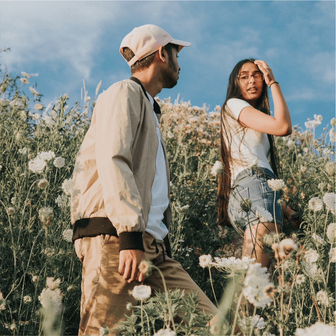 two happy and healthy friends walking through nature