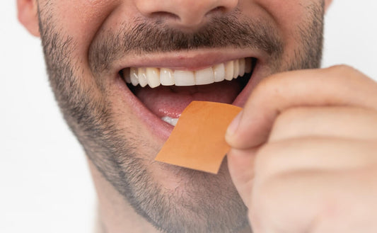 A man holding BIOSTRIPS™ Supplement's on his tongue, which rapidly dissolves ont the tongue illustrating the convenient and quick consumption of dietary supplements, as discussed in the blog about understanding the need for supplements in modern nutrition