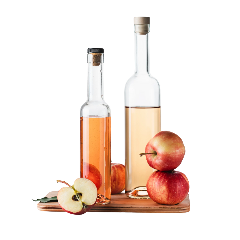 Two bottles of apple cider vinegar with apples on a white background