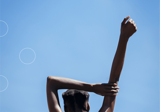 Clear blue sky with woman stretching one hand into the air and BIOSTRIPS logo
