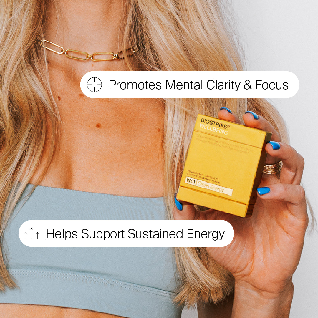 Woman using BIOSTRIPS Clean Energy strip during a workout for an energy boost.