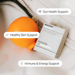 BIOSTRIPS Essentials box with an orange on a textured surface, labeled for gut health, skin support, and immune energy.